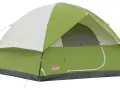 A green and white Coleman Sundome 4 person tent, ready for adventure. Learn about its dimensions for your next camping trip.
