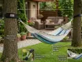 Learn how to hang a hammock between two trees using straps and carabiners for a perfect backyard relaxation spot.