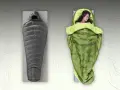 A gray sleeping bag and a green quilt with a woman sleeping in it. Choosing between a quilt vs sleeping bag for your next adventure.
