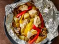Chicken, potatoes, peppers, and mushrooms cooked in foil. Wondering how long to cook tin foil dinners in fire for this delicious meal?