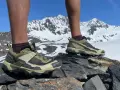 Salomon X Ultra 5 GTX shoes on rocky terrain with snowy mountains in the background. Ready for any adventure.