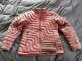 A maroon puffer jacket lies on a dark, wrinkled surface, ready for cleaning. Learn how to wash a down jacket to keep it fluffy and warm.