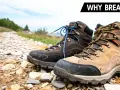 Two hiking boots sit on a rocky trail, ready for adventure. Learn how to break in hiking boots for comfort on your next trek.