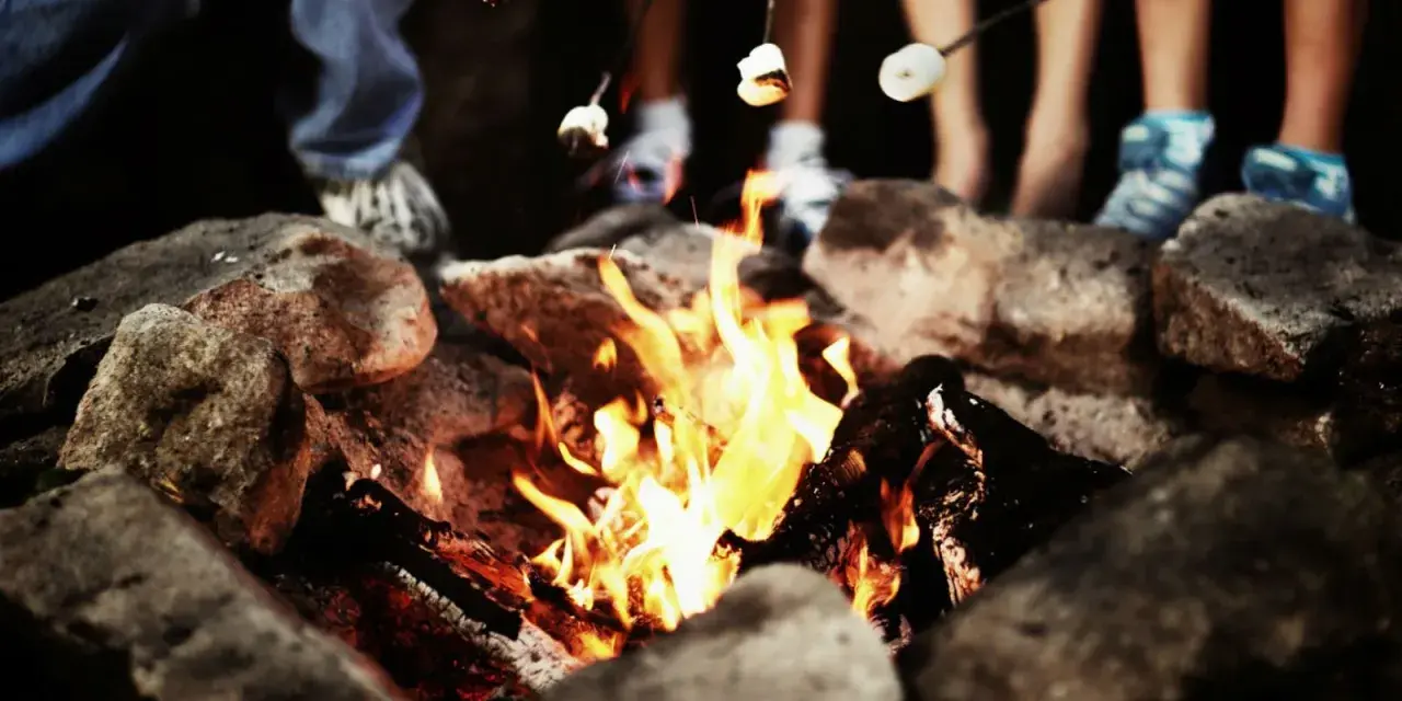 Marshmallows toasting over a campfire, perfect for camp fire songs and sweet memories.