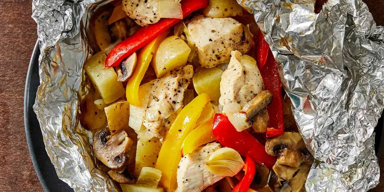 Chicken, potatoes, peppers, and mushrooms cooked in foil. Wondering how long to cook tin foil dinners in fire for this delicious meal?