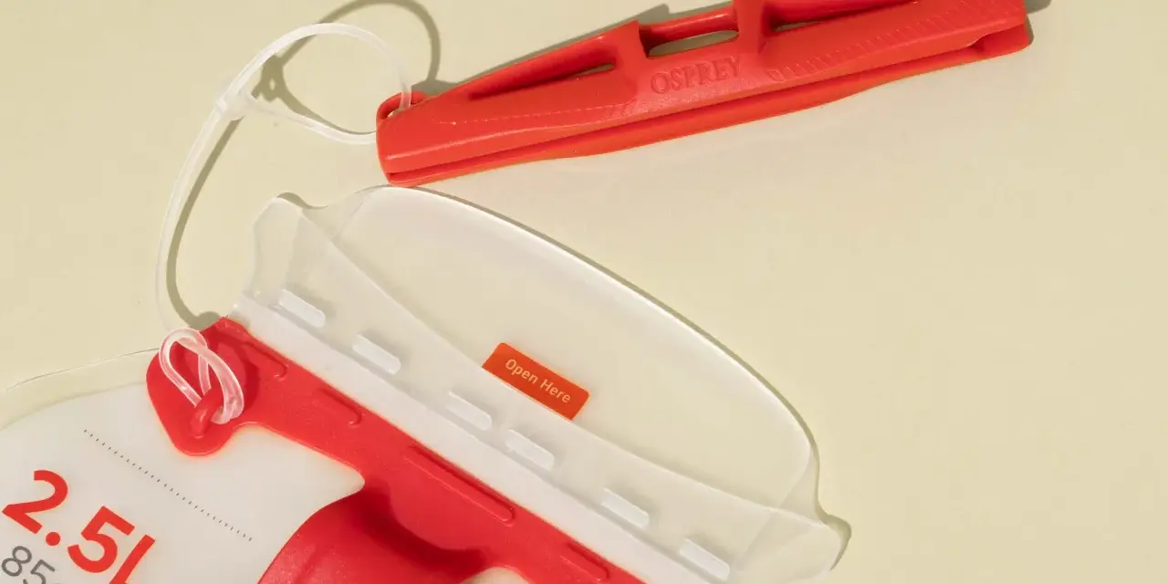 An Osprey 2.5L hydration pack with a red bite valve and a clear opening. This hydration pack is perfect for staying hydrated on the go.