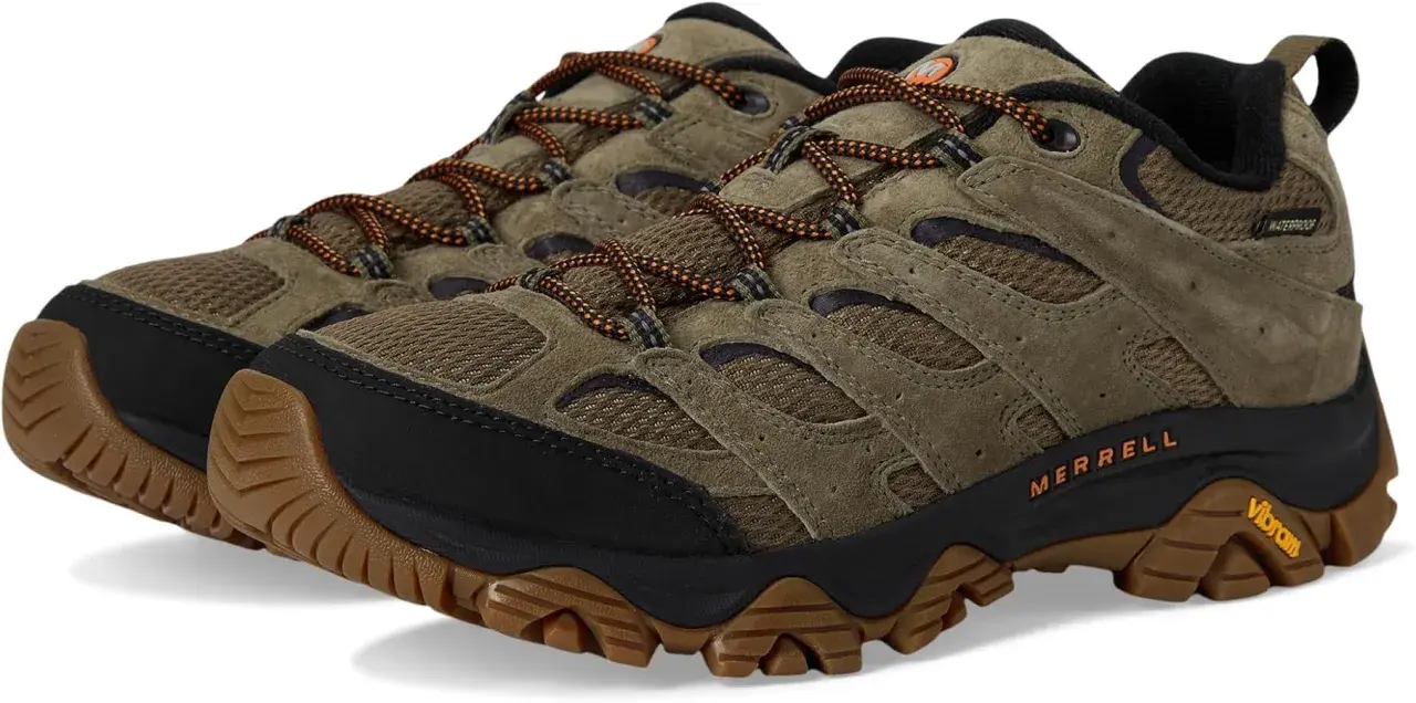 A pair of olive green Merrell Moab 3 waterproof hiking shoes with orange laces and Vibram soles.