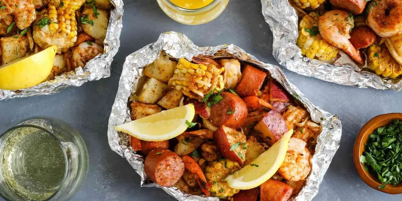 Foil packets filled with shrimp, sausage, corn, and potatoes. These are perfect for easy camping meals, served with lemon wedges and melted butter.