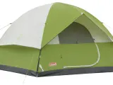A green and white Coleman Sundome 4 person tent, ready for adventure. Learn about its dimensions for your next camping trip.