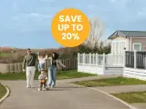 Family enjoys a sunny day near mobile homes, perfect for location de mobil-homes pas cher. Save up to 20%!