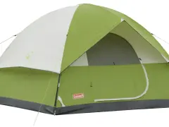A green and white Coleman Sundome 4 person tent, ready for adventure. Learn about its dimensions for your next camping trip.