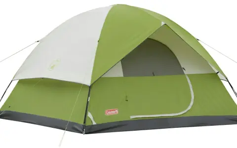 A green and white Coleman Sundome 4 person tent, ready for adventure. Learn about its dimensions for your next camping trip.