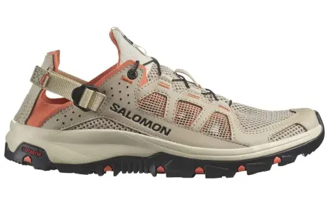 A beige and orange Salomon Techamphibian 5 sandal-shoe hybrid with a mesh upper and Contagrip sole, perfect for amphibious adventures.
