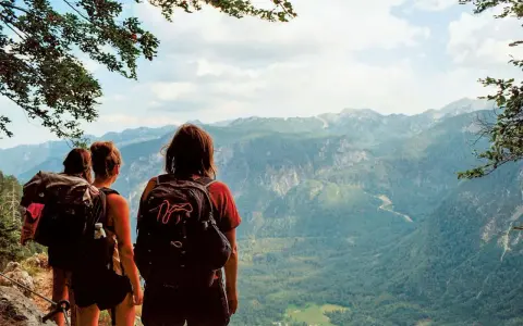 Hikers pause on a pyrenees trail, taking in the breathtaking mountain vista.