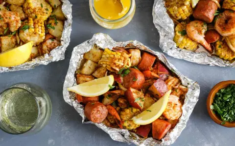 Foil packets filled with shrimp, sausage, corn, and potatoes. These are perfect for easy camping meals, served with lemon wedges and melted butter.