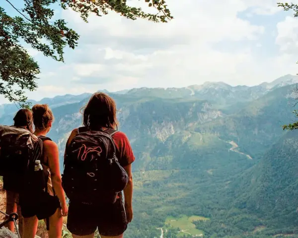 Hikers pause on a pyrenees trail, taking in the breathtaking mountain vista.