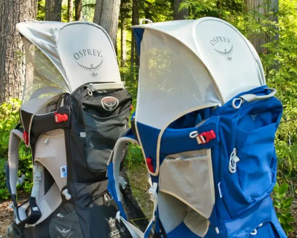 Two Osprey Poco Plus child carriers in black and blue, ready for adventure. Check the Osprey Poco Plus weight limit for safe hiking.
