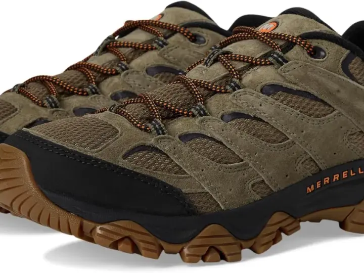 A pair of olive green Merrell Moab 3 waterproof hiking shoes with orange laces and Vibram soles.