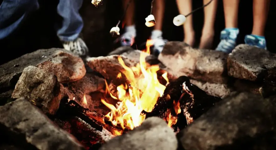 Marshmallows toasting over a campfire, perfect for camp fire songs and sweet memories.