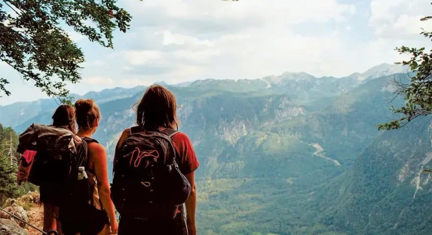 Hikers pause on a pyrenees trail, taking in the breathtaking mountain vista.
