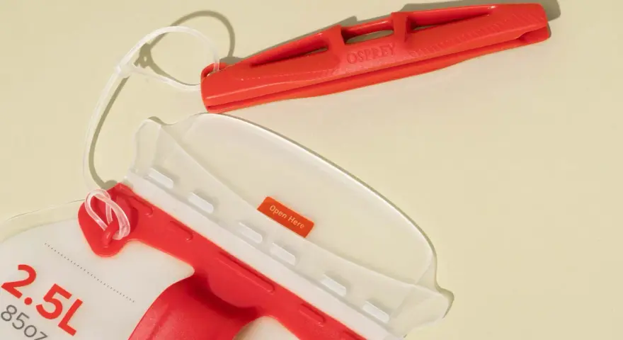 An Osprey 2.5L hydration pack with a red bite valve and a clear opening. This hydration pack is perfect for staying hydrated on the go.