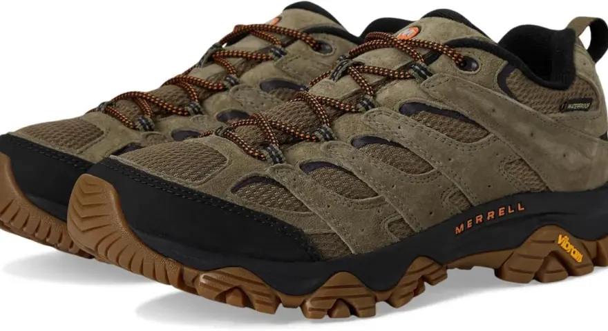 A pair of olive green Merrell Moab 3 waterproof hiking shoes with orange laces and Vibram soles.