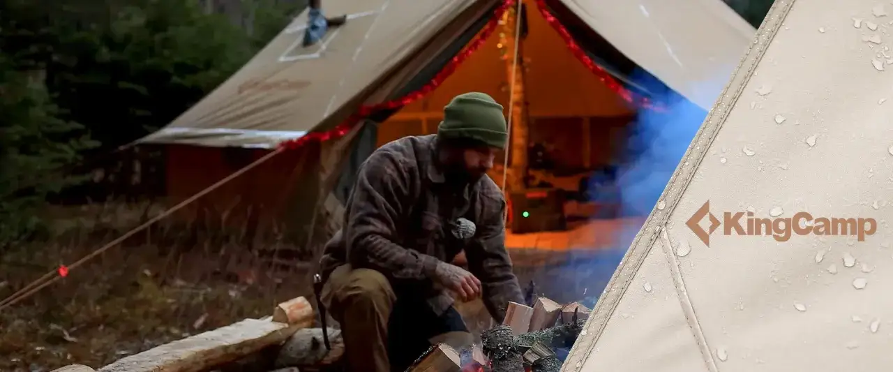 Man tending a campfire outside a tent, preparing for a camping trip. Tips on how to plan a camping trip are essential for a successful adventure.