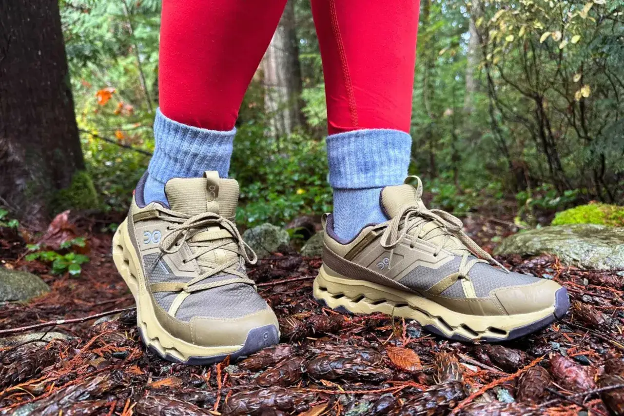 Choosing the right hiking boots is key for a comfortable trek. These tan boots with red leggings are ready for the trail.