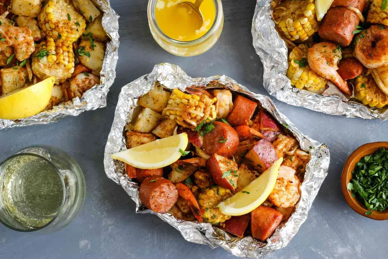 Foil packets filled with shrimp, sausage, corn, and potatoes. These are perfect for easy camping meals, served with lemon wedges and melted butter.